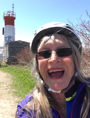 73 years old woman, enjoying cycling outdoors