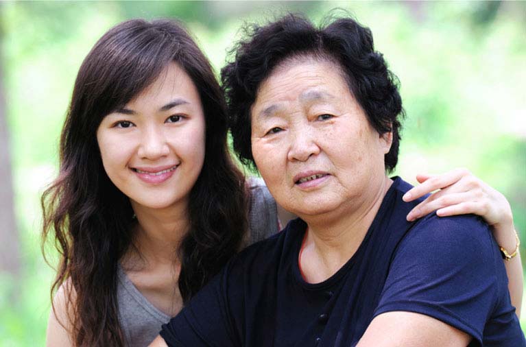 Daughter embracing mom