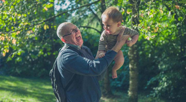 Grandfather lifting his grandson