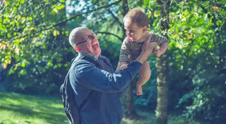 Grandfather lifting his grandson