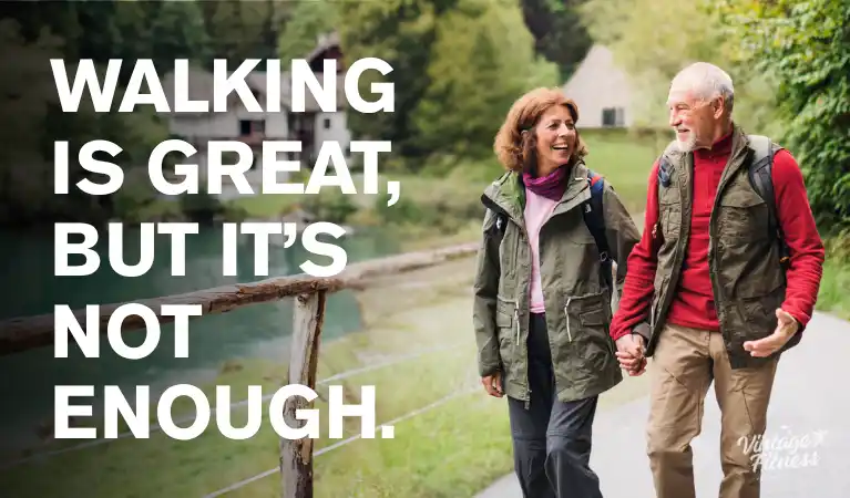 Happy senior couple walking hand in hand on an outdoor trail, with the message: walking is great, but it's not enough