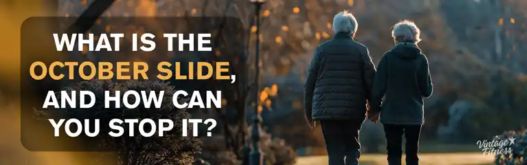 Senior couple walking on autumn path with falling leaves discussing October Slide joint pain and fatigue with Vintage Fitness